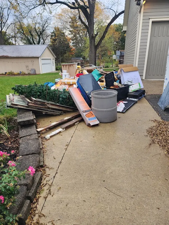 Dumpster being loaded with debris for 10 Yard Dumpster Rental in Godfrey
